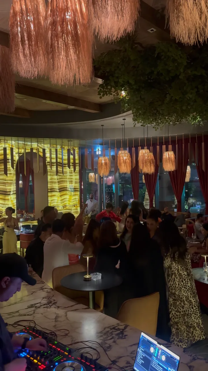 A packed restaurant at night, every table taken