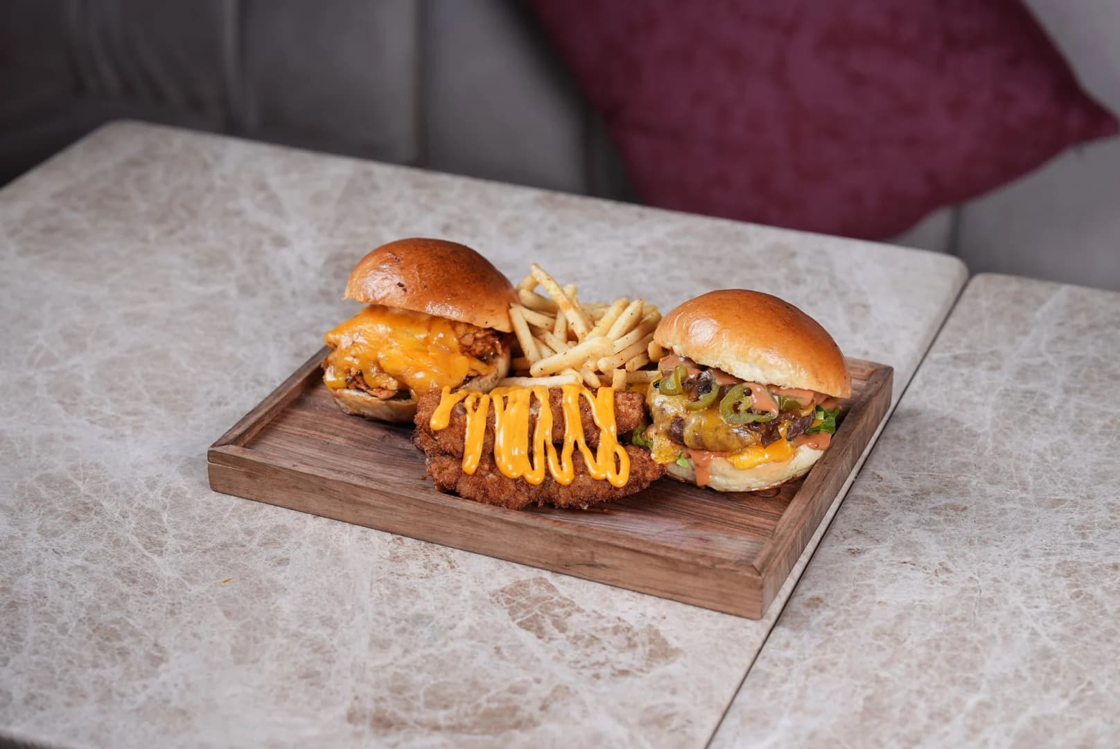 Chicken burgers and fries on a wooden board