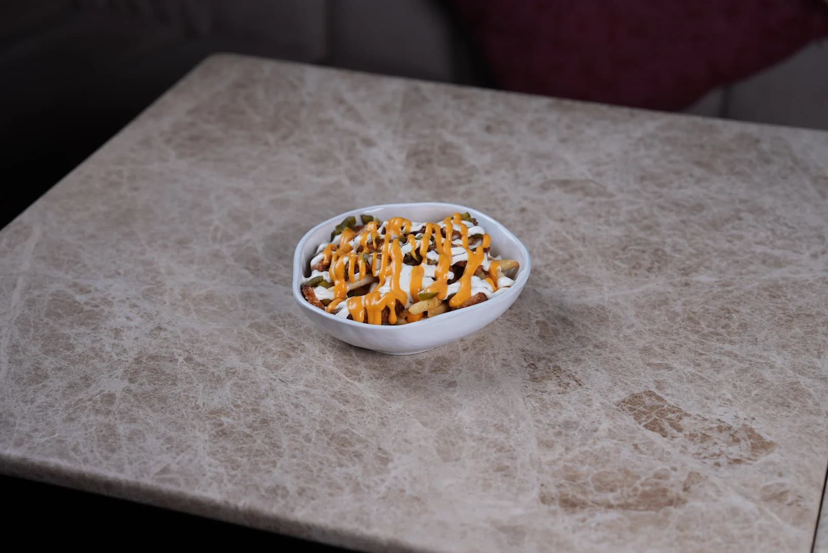 Loaded fries in a white bowl
