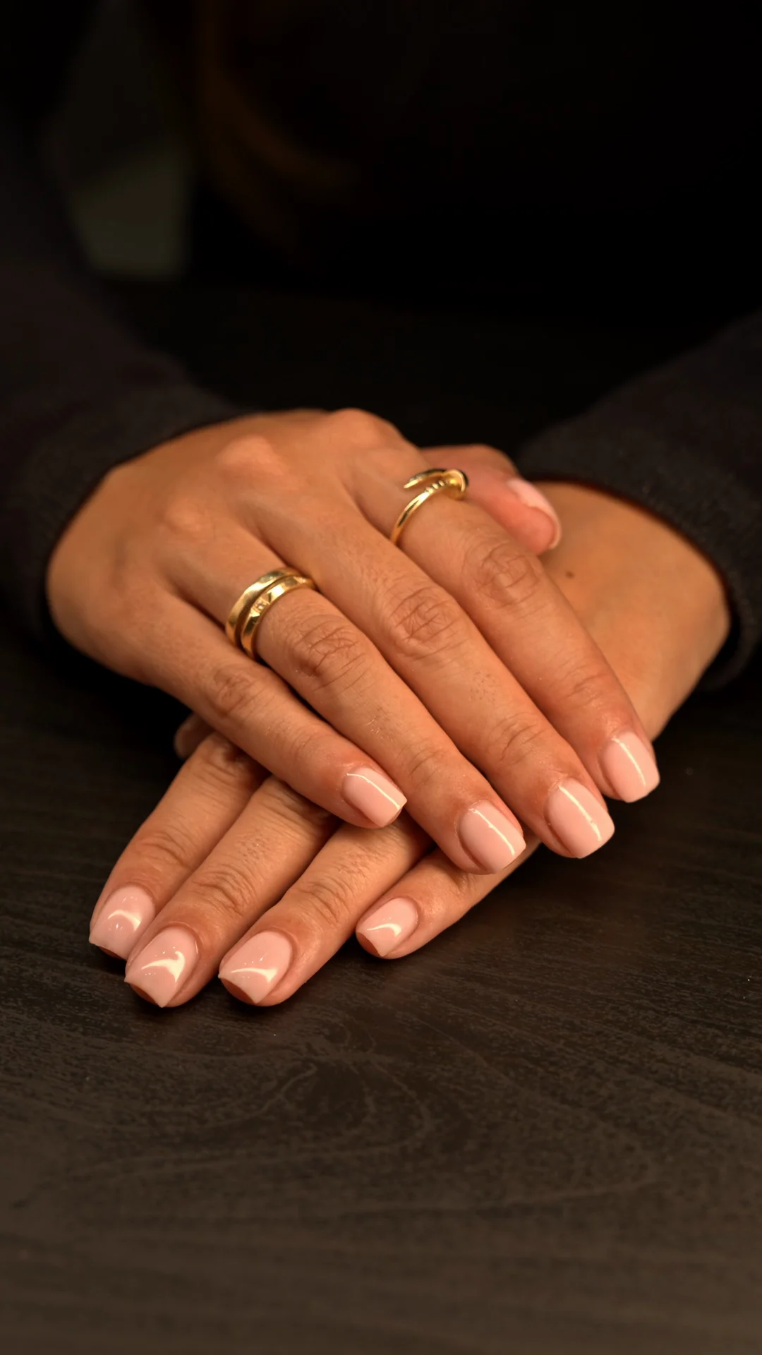 Hands with a pale pink manicure