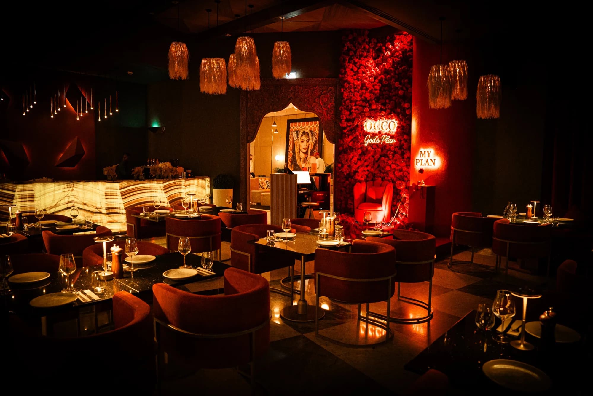 Dining room with a red rose wall at OCCO Business Bay