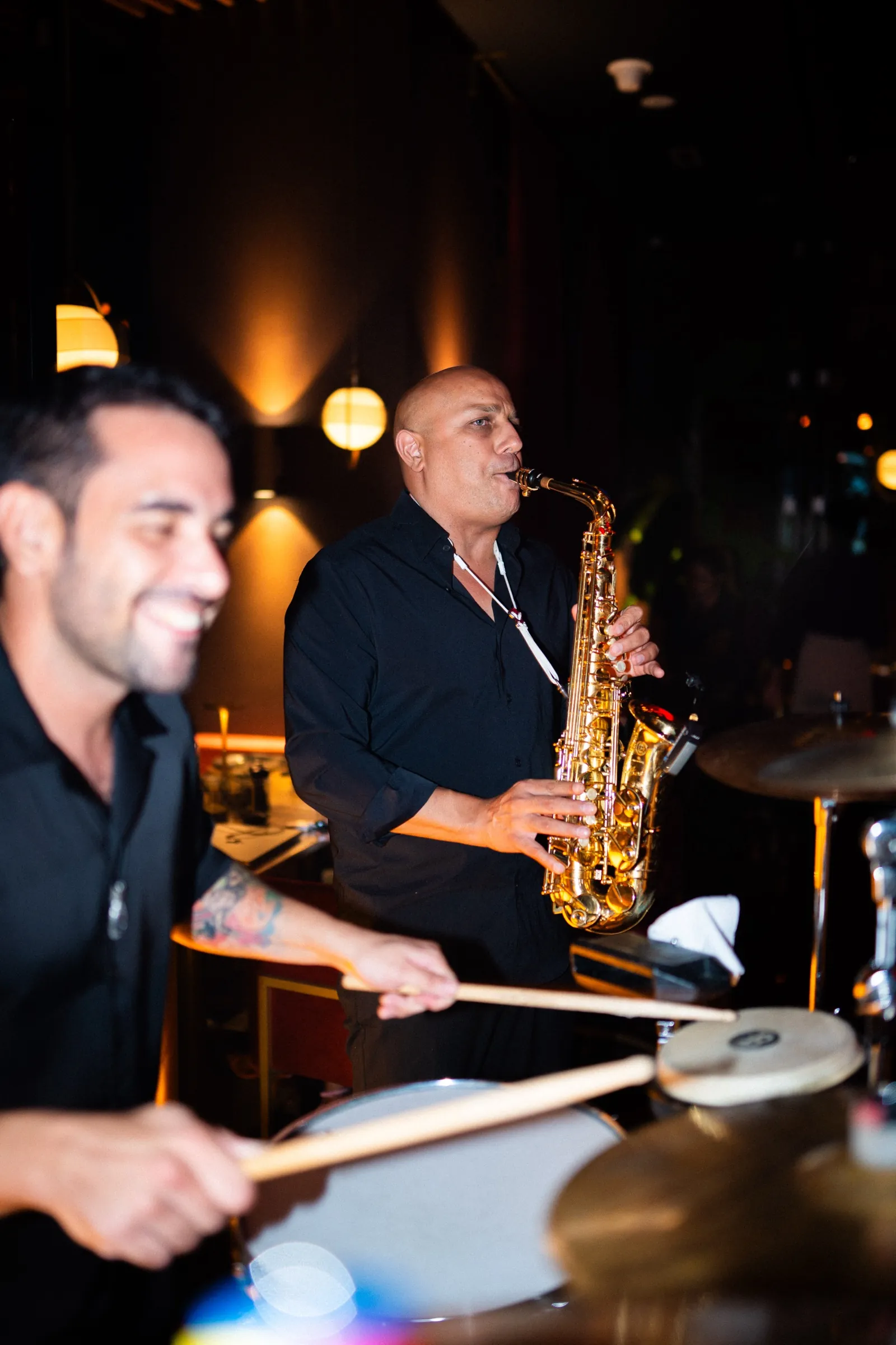 Drummer and saxophonist playing live
