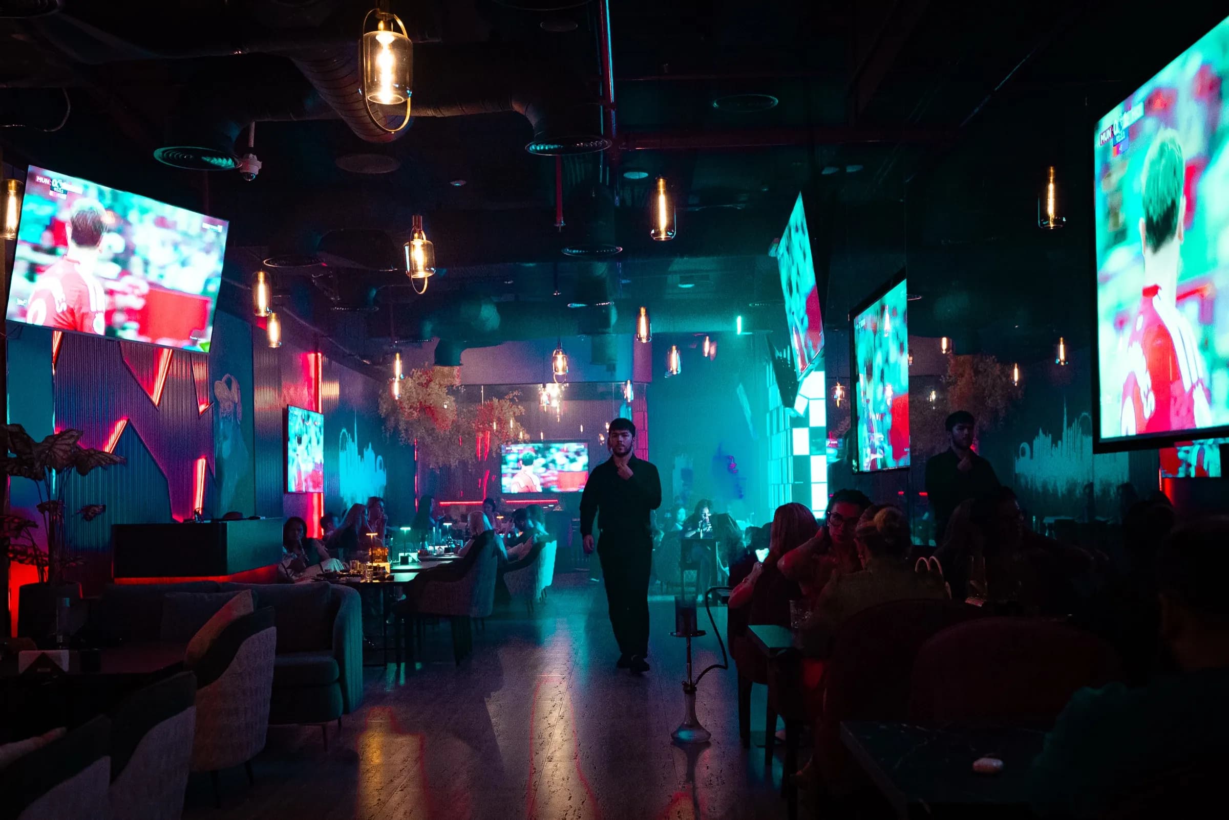 Vesna's lounge on a match night, football on the screens