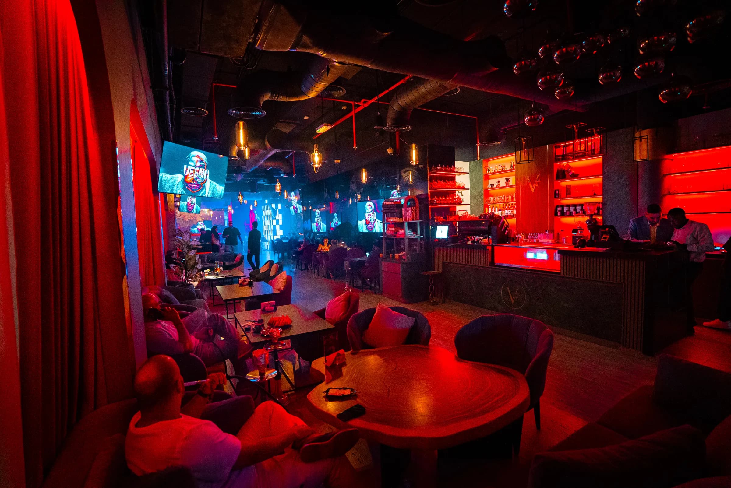 Vesna's lounge at night, its name on the screens