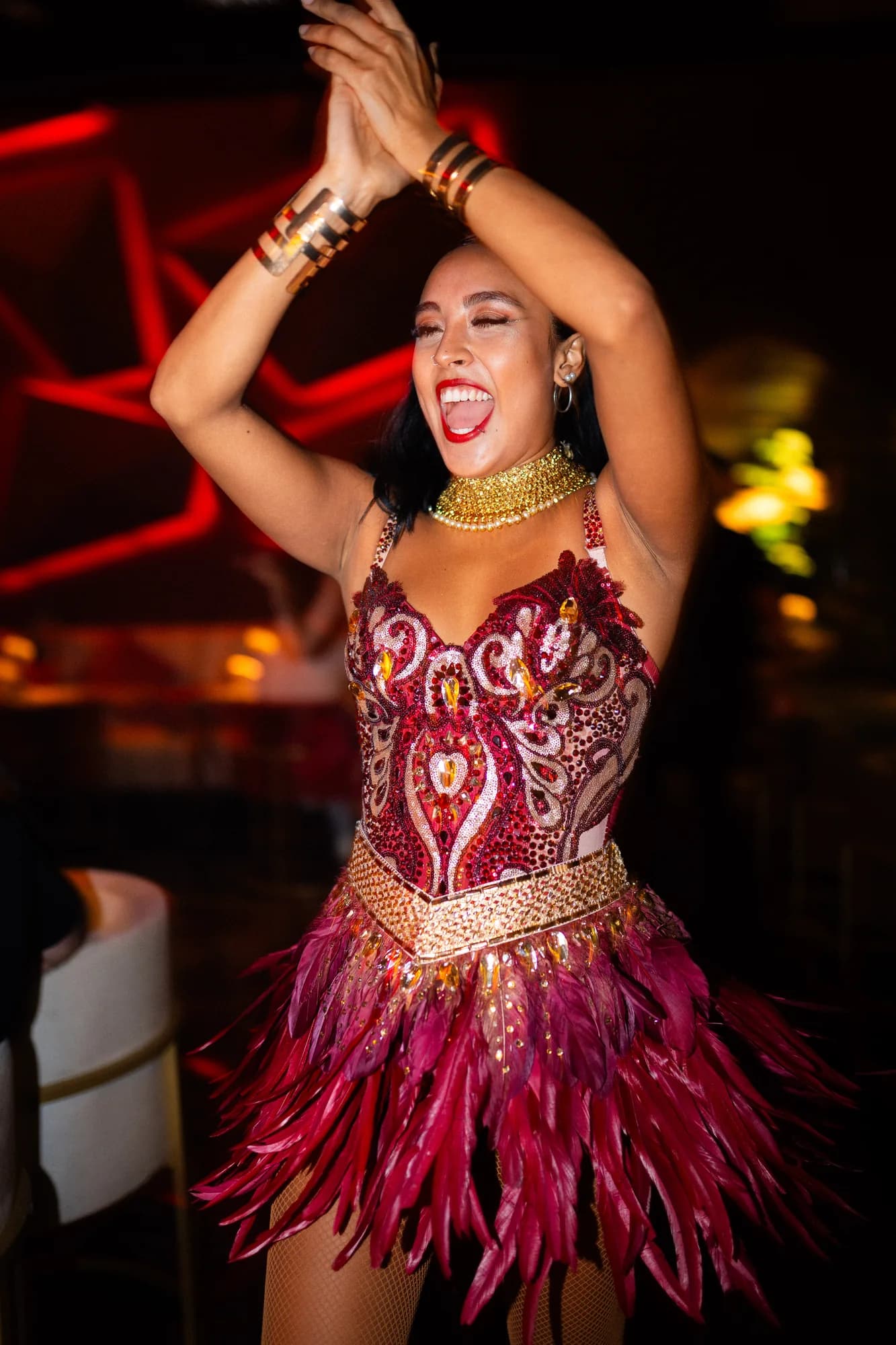 Dancer laughing with her arms raised