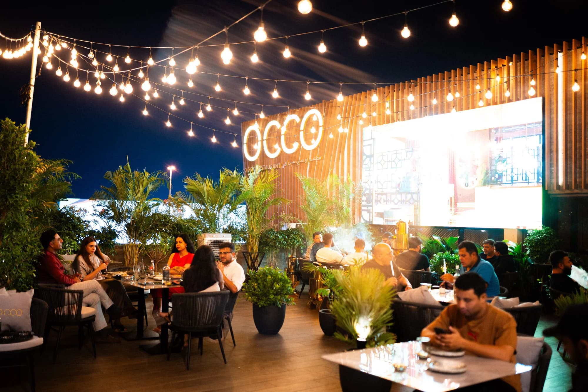 Guests on the terrace at OCCO Hessa Street at night