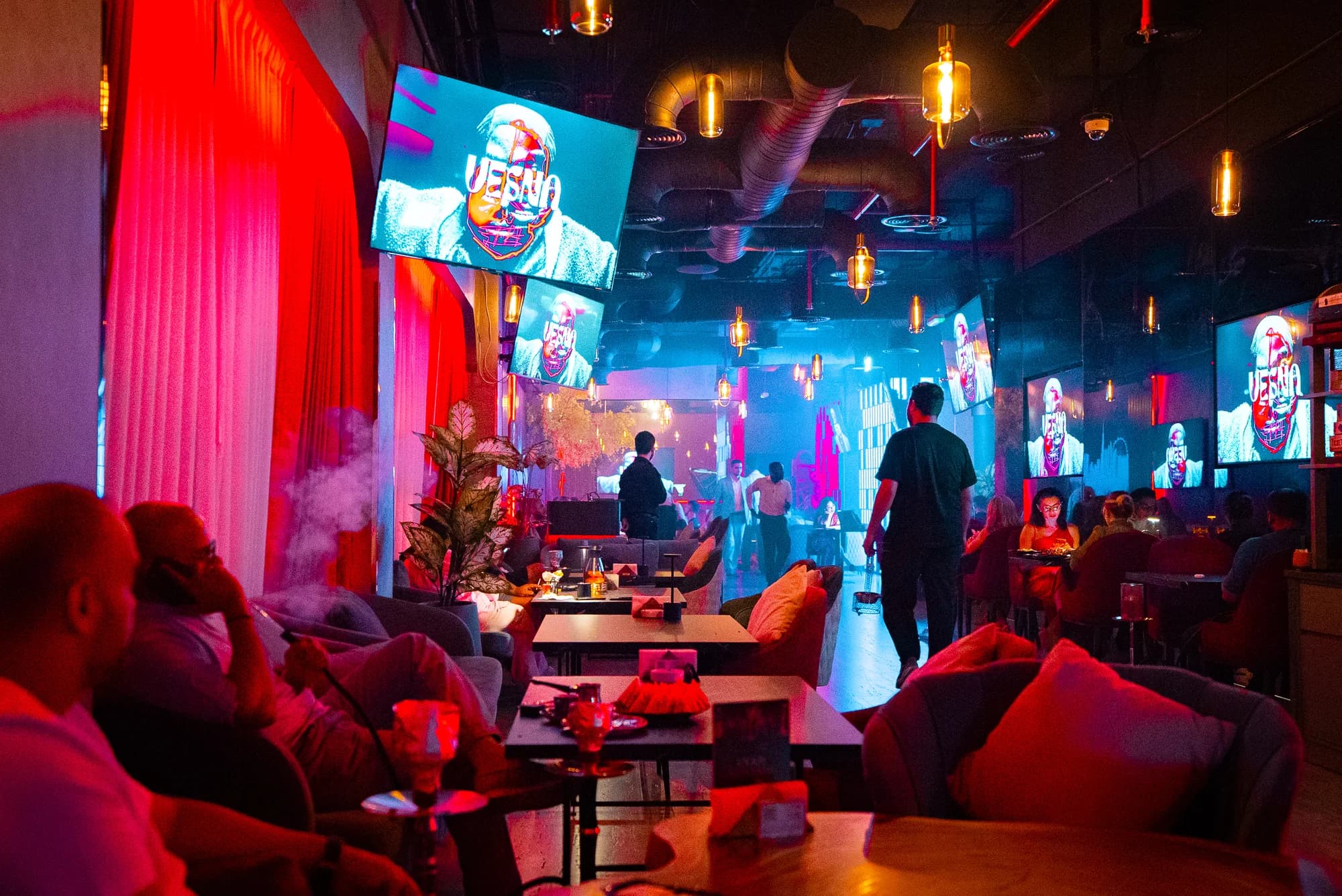 Vesna's lounge with red curtains and screens